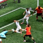 Ten-man Belgium survive Iran scare
